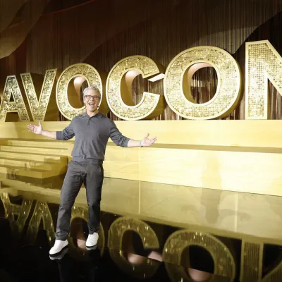 Andy Cohen welcomes the crowd in front of giant gold BravoCon letters on the Gold Stage