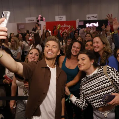 A Bravo star takes a selfie with a crowd of smiling fans
