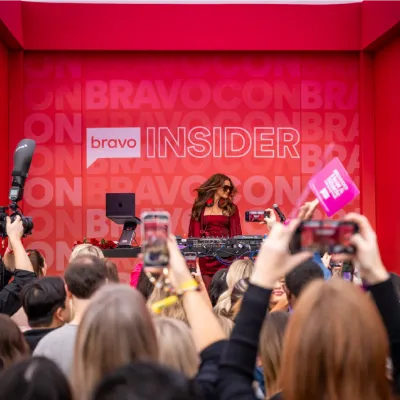 Fans film a DJ set on the Bravo Insider stage